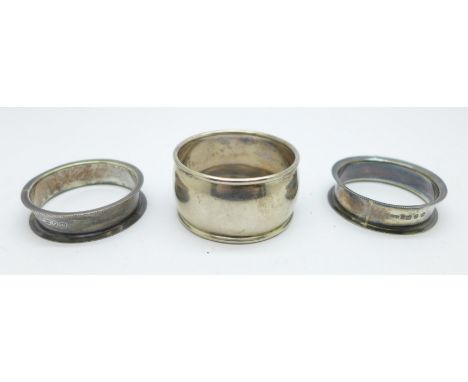 A pair of late Victorian silver napkin rings and one other silver napkin ring, 32.7g 