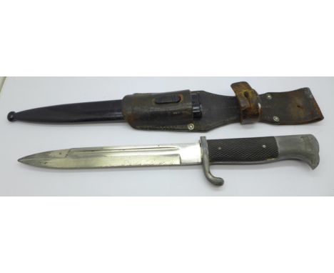 A bayonet with leather frog and metal scabbard 