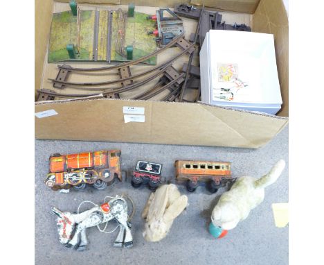 A tin-plate train set with track, level crossing, a Muffin the Mule cast metal puppet, a clockwork rabbit marked Made in Japa