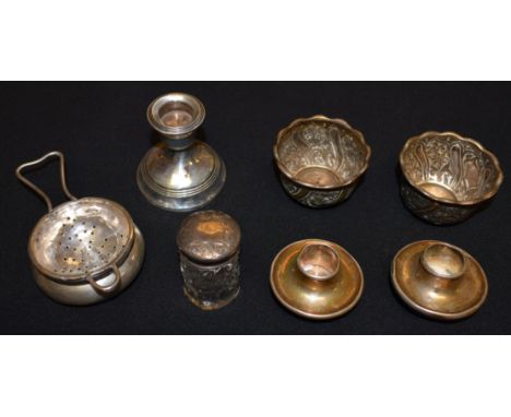 A pair of Victorian silver salts, embossed with foliate scrolls, London 1886; a silver tea strainer on stand, Birmingham 1939