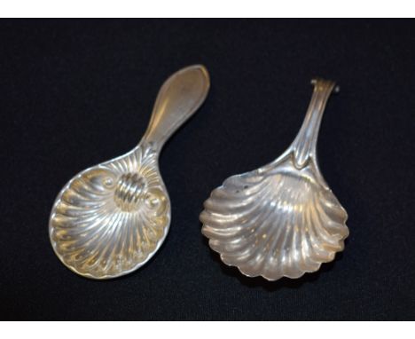 An early 19th century silver caddy spoon, as a scallop shell,  Birmingham 1835; another similar caddy spoon (2)