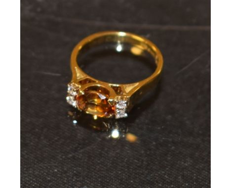 An 18ct gold diamond and topaz ring