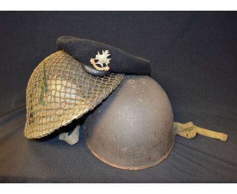 A tin helmet, a cloth beret, Sherwood Foresters, Notts and Derby badge, dated 1945; another helmet (3)