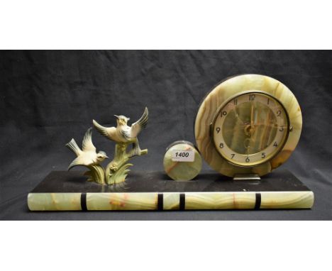 An Art Deco spelter, onyx and black marble mantel clock, circular dial, Arabic numerals, flanked by a pair of birds amongst b