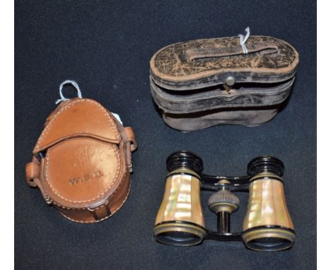 A leather cased compass; a pair of cased opera glasses