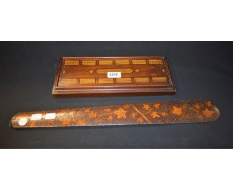 A poker work page turner, detailed with trailing ivy, 53cm; a Victorian mahogany inlaid cribbage board, with hinged compartme