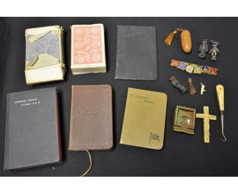 A Paris souvenir bracelet; a WWII period prayer book; a needle case; a button hook; a carved bone prisoner of war type crucif