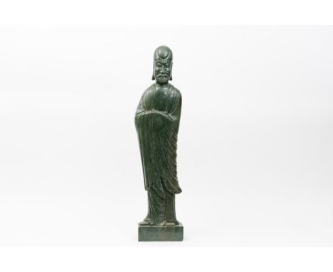 A monumental carved spinach jade figure of a lohanChina, Qing dynasty, late 19th centuryProvenance: French private collection