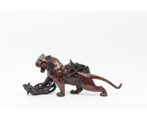 A bronze model of a tiger and wolvesMeiji period (1868-1912), circa 1880-1890Naturalistically-modeled as a tiger in a struggl