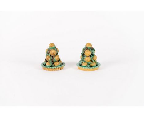 A pair of famille verte biscuit models of piles of walnutsChina, Qing dynasty, Kangxi period (1662-1722)Each set within a lob