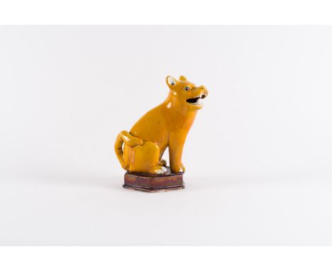 A yellow glaze porcelain figure of a seated dogChina, Qing dynasty, Kangxi period (1662-1722)Provenance: French private colle