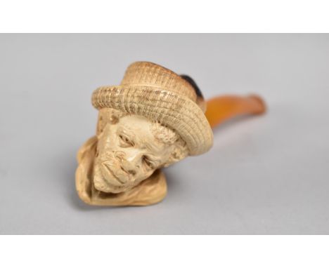 A Carved Meerschaum Pipe with Amber Mouthpiece, Bowl in the Form of Bearded African Gent with Feather in Cap, Mouthpiece 13cm