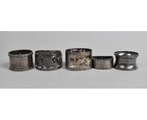 A Collection Napkin Rings to Include Four Silver Examples and One Plated Example 