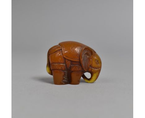 A Small Carved Netsuke in the Form of an Elephant, 4cms Long 
