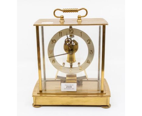 A 1950's brass open face mantle clock, Kumba Electronic, in glass hood
