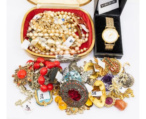 A collection of costume jewellery to include a silver Edwardian mother of pearl and enamel brooch along with various gilt and