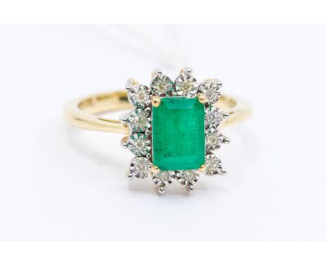 An emerald and diamond 18ct gold cluster ring, comprising a claw set step cut emerald to the centre, stone weight just over 1