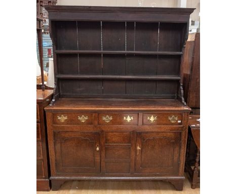 18th Century oak kitchen dresser with plate rack, three top drawers over two cupboard, doors, on bracket feet and brass swing