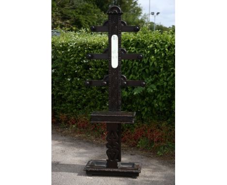 A late 19th Century ebonised hall stand, with coat rack and stick stand sections, metal trays to base, moulded edges