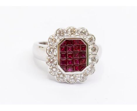 A ruby and diamond 18ct white gold cluster ring, the checker board centre set with five rows of square and triangular cut rub