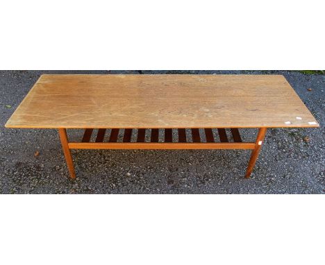 Long 1970's oak coffee table with magazine shelf