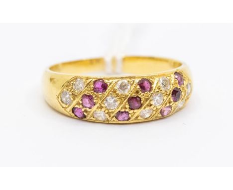 A ruby and diamond 18ct gold dress ring, comprising alternate diagonal rows of grain set diamonds and rubies, width approx 6m