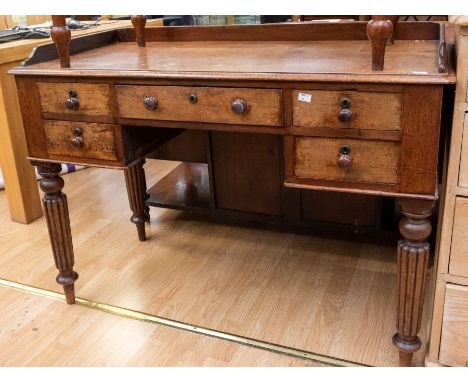 A 19th Century Victorian mahogany desk, gallery topped, two drawers either side of central drawer, with knob handles