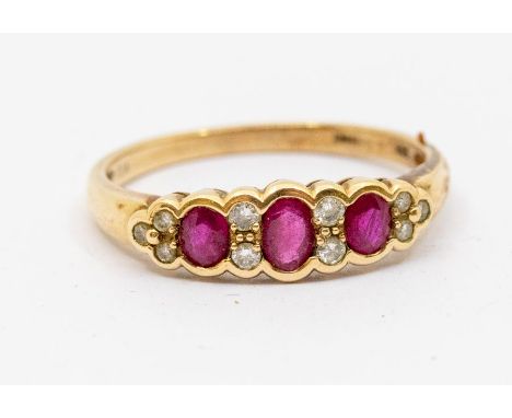 A ruby and diamond 9ct gold ring, comprising three oval cut rubies with double set diamond accents, size W, total gross weigh