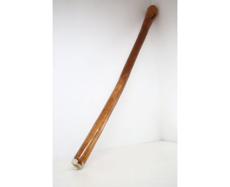 A plain wooden didgeridoo