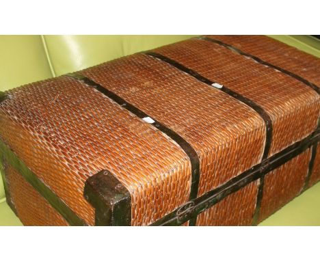 An early 20th Century wicker and iron bound travelling trunk