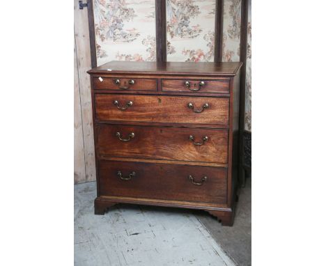 A George III mahogany chest of drawers, fitted with two short drawers and three long graduated drawers, all drawers with bead