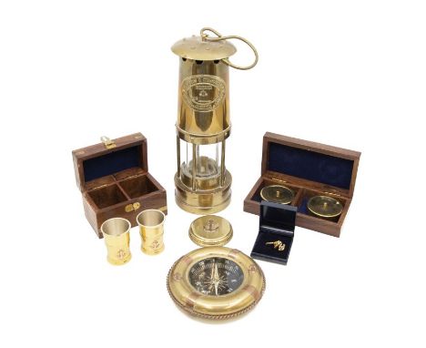 A brass miners lamp, E Thomas &amp; Williams Ltd number 85845; brass and copper life ring compass, shot glasses in box, calen