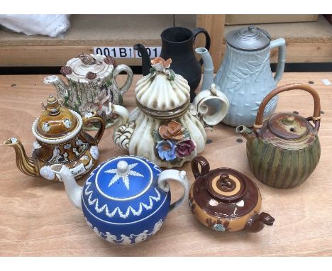 A collection of ceramic teapots, to include:- an example for Bourton on the water with a whicker handle; an Italian example w