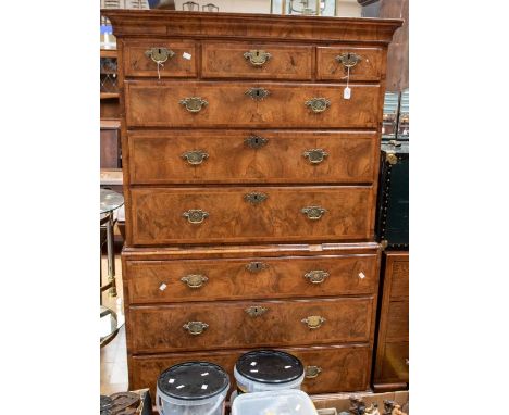 A George I walnut bookmatched chest on chest, circa 1720, the upper section with three short drawers over three long graduate
