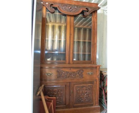 Victorian mahogany dresser, upper section glazed with wooden shelves, lower section with two cupboard doors and a central dra