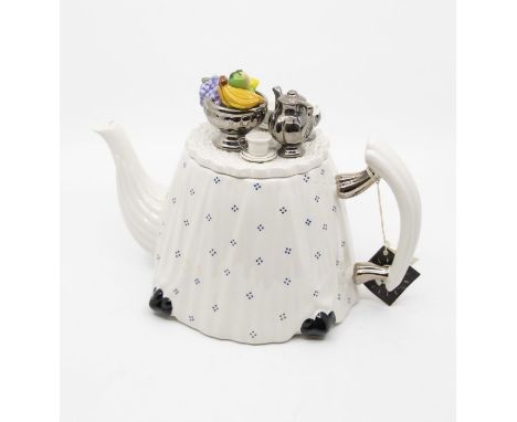 A Cardew china teapot designed by Paul Cardew, the body table shaped with white and blue table cloth, the cover applied with 