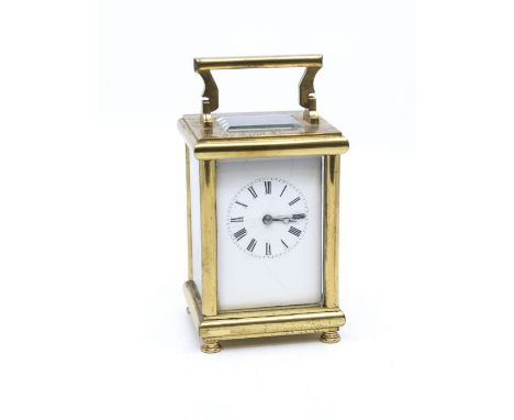 A brass cased carriage clock, the white enamel dial with Roman numerals (hairline cracks to dial), the body and the movement 