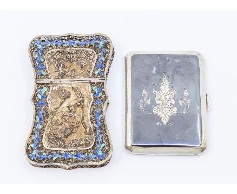 A Thai white metal filigree and blue enamel shaped cigarette case, the front and back decorated with Dragon and flowers in hi