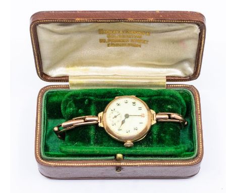 An early 20th century Ladies 9ct rose gold watch, round enamel dial with number markers and subsidiary dial, (cracks to dial)