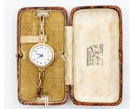 An early 20th Century ladies 9ct gold watch, round white enamel dial with pained numerals, gold tone dot seconds track, case 