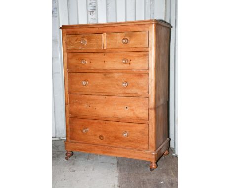 A Victorian pine chest of drawers, comprising two short over four long graduated drawers, most drawers retaining original han