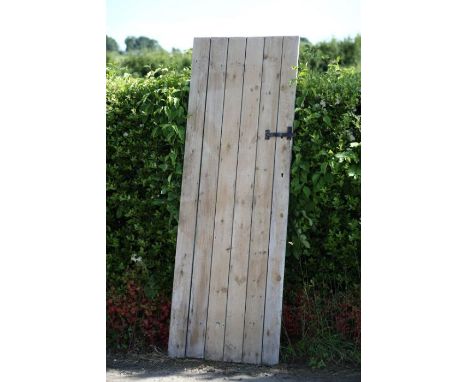 A pine shed door, with wrought iron handle and lock
