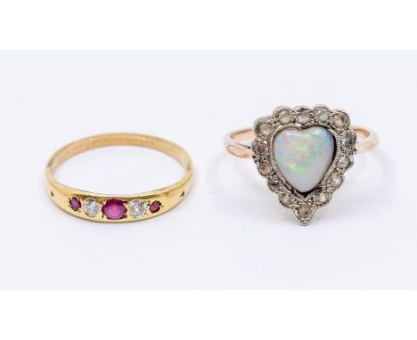 An early 20th century opal 9ct gold ring, comprising a heart shaped opal within a border of small white topaz, size N, total 