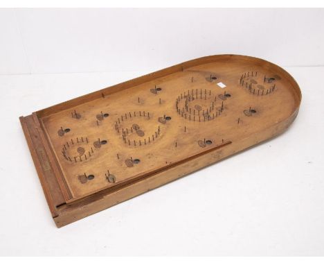 A vintage Bagatelle board with cue