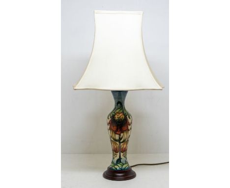 A late 20th Century Moorcroft table lamp, with shade, on wooden stand