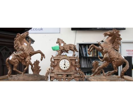 A spelter clock with two Culson matching garnitures, central mantle clock with horse figure above dial (AF)