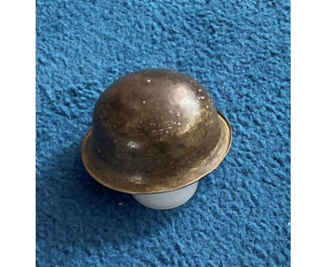 The Nose of an artillery bomb, been moulded into a small round bowl/helmet. A rare and unique item. Bomb would have been drop
