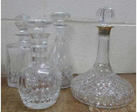 A ship's decanter with silver rim and three other decanters