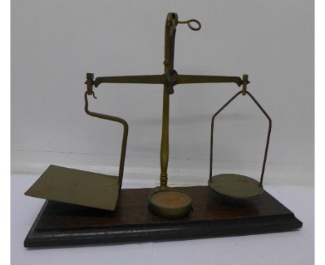 A set of balance scales with one weight