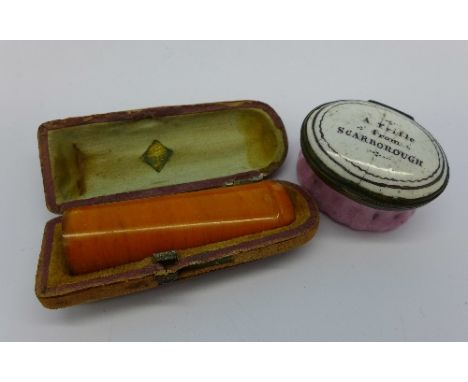 A 19th Century enamel patch box, 'A Trifle from Scarborough' and an amber cheroot holder, cased, a/f